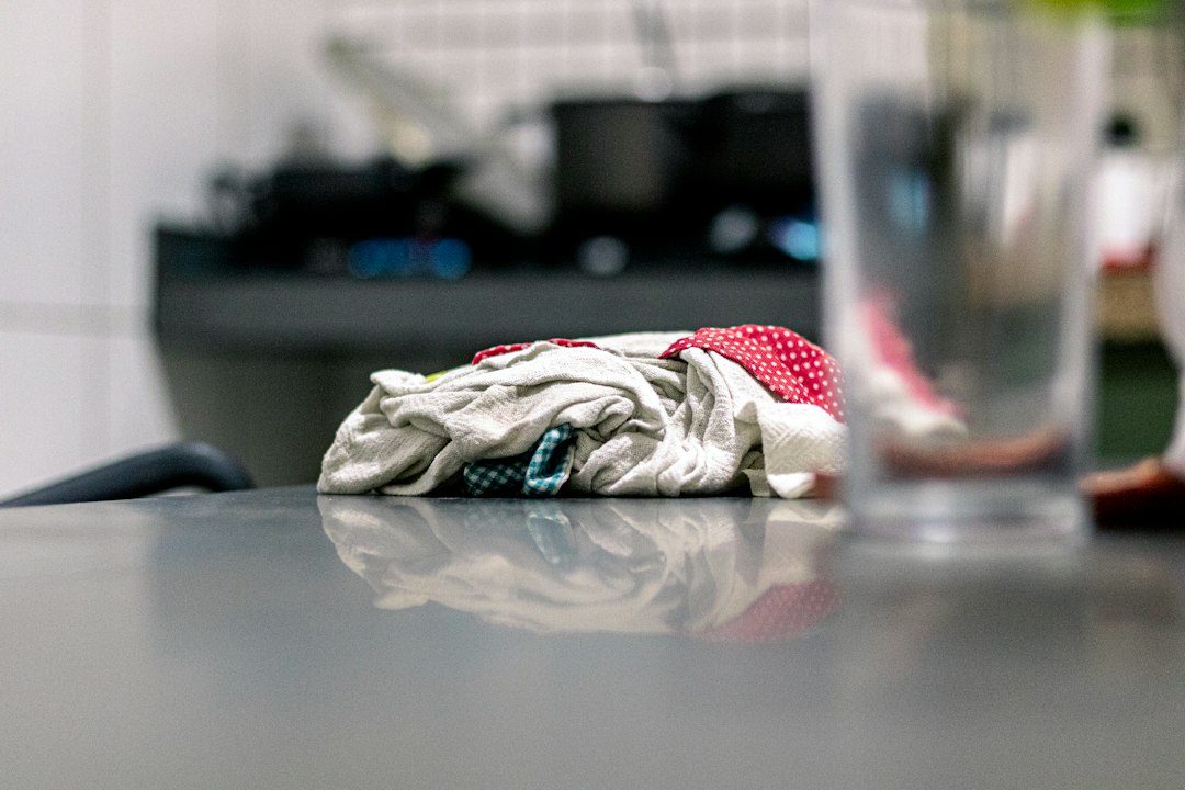 Crumpled cloth on a reflective surface in a blurry kitchen