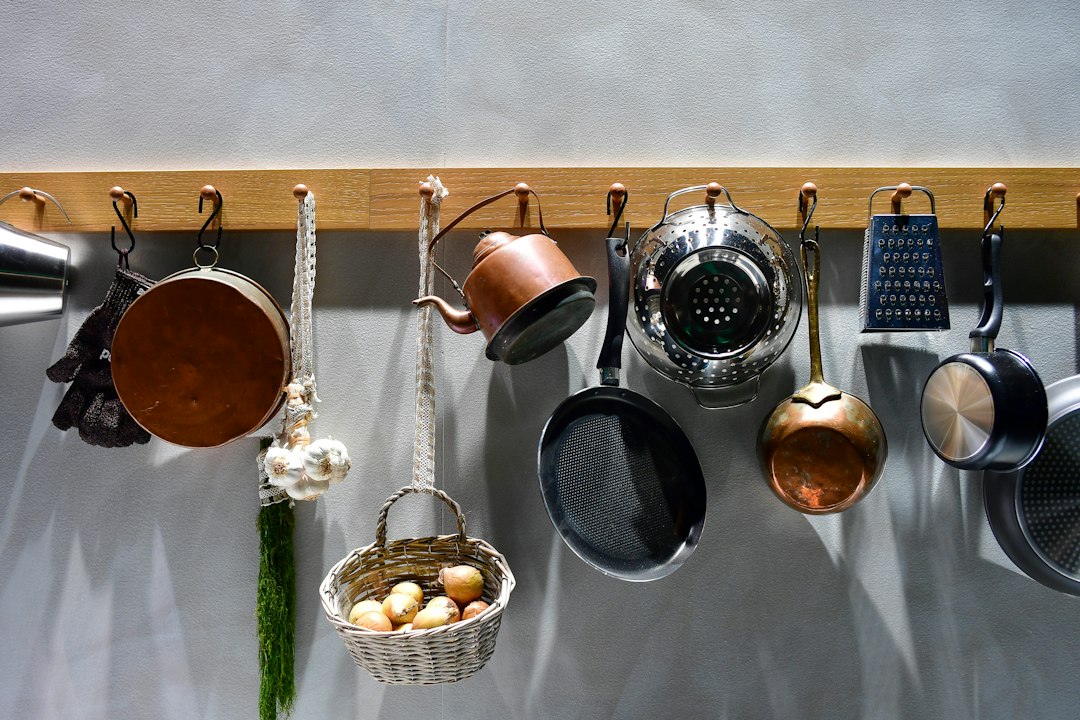 Various kitchen utensils hanging on a wooden rack